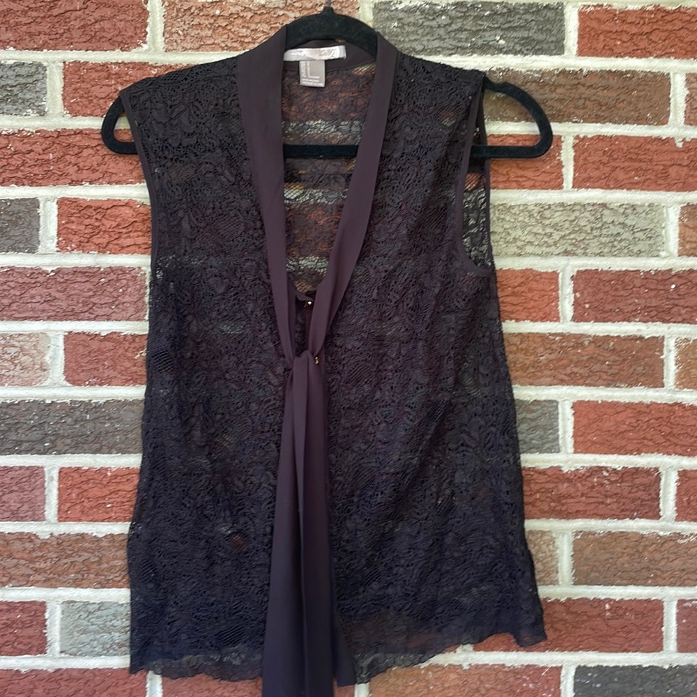 Black lace sleeveless top with solid collar and gold buttons. Size is a small.